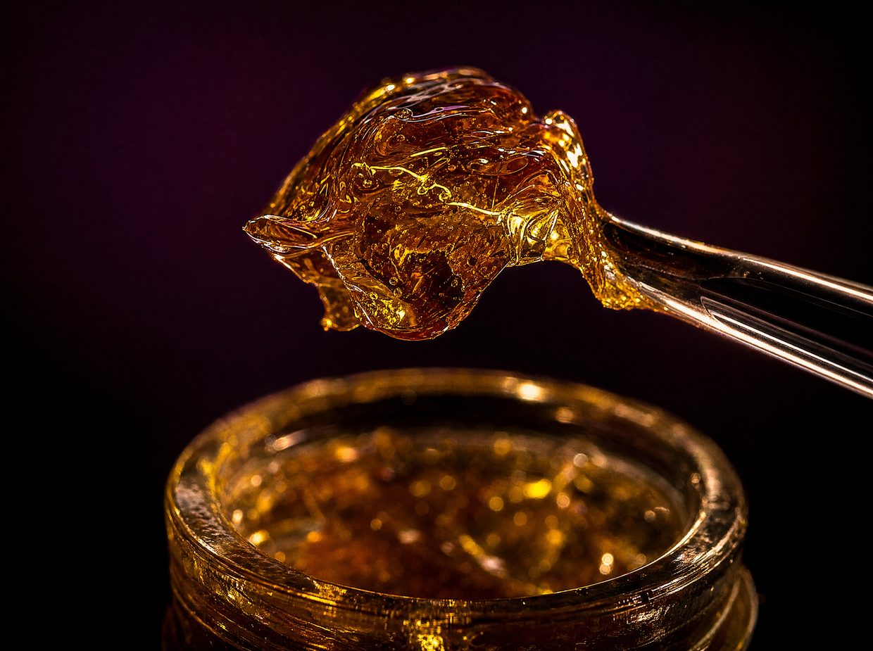 Golden-amber live resin concentrate on a dab tool