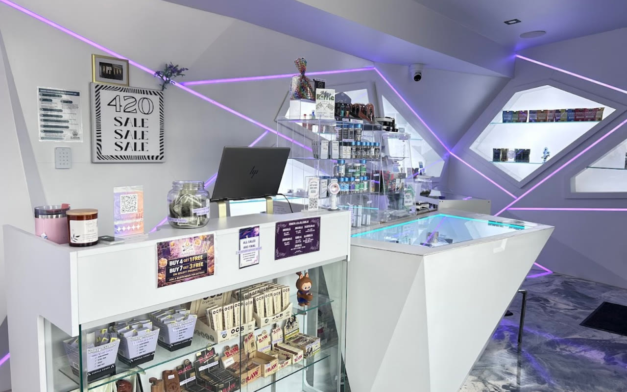Inside Purple Co. — Forest Ave, Portland: white geometric counters under purple laser lighting